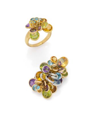 a pair of rings with multicolored stones and gold