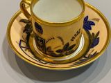 a cup and saucer sitting on a table