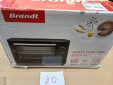 a toaster oven sitting on a table with a price tag
