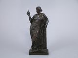 a bronze statue of a woman holding a cigarette in her hand