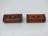 two wooden boxes with handles and handles on a white surface