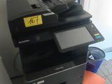 a printer sitting on top of a cabinet in a room