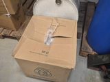 a box that is sitting on a pallet next to a barrel