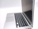 a silver laptop computer sitting on a white surface