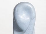 marble sculpture of a woman ' s head on a white pedestal