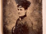 an old photo of a woman with a feather on her head