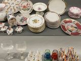 many different types of plates and glasses on the table