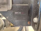 a close up of a machine with a clock on it ' s side