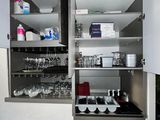 a cabinet that has a lot of dishes and glasses on it