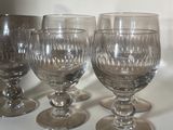 four wine glasses lined up on a table