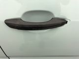 a close up of a door handle on a white car