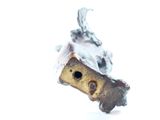 a close up of a small metal object on a white surface