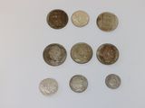 several different coins are arranged in a circle on a white surface