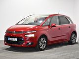 a red citrole is parked in a room with a checkered floor