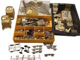 a box full of assorted metal items on a white surface