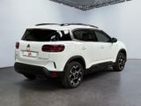 the rear end of a white suv parked in a garage