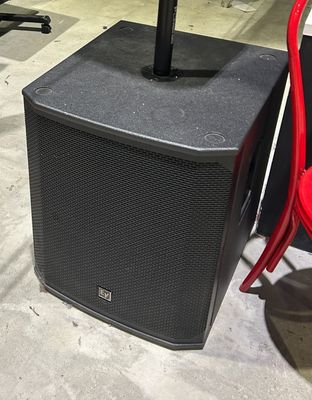 a red chair and a speaker in a room