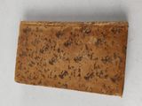 a close up of a piece of wood on a white surface