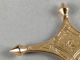 a gold star with a crown on it on a table