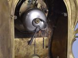 a clock that is sitting on a shelf in the room