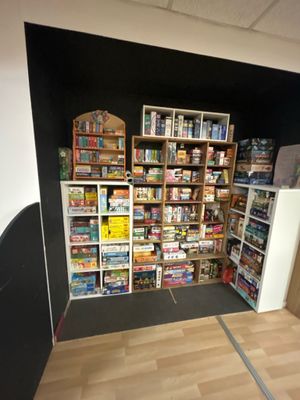 a room with a lot of food and games on the shelves