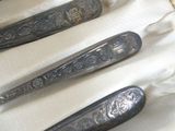 four spoons that are sitting on a white cloth