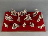 silver figurines of soldiers on a red display board