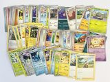 a lot of pokemon cards that are on the table