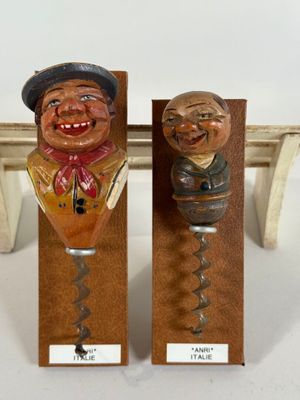 two wine openers that are sitting on a table