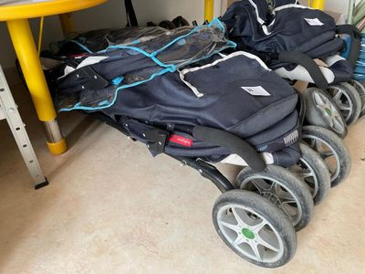 many bags of luggage sitting on the floor next to a yellow table