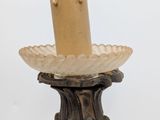 a close up of a candle holder with a candle on top of it