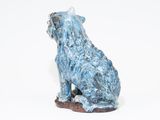 a statue of a dog that is sitting on the ground