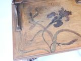 a wooden tray with a flower design on it