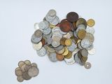 a pile of coins sitting on a table next to a pile of coins
