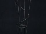 a black and gold coat rack with five pairs of scissors