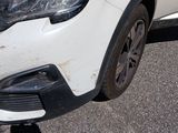 a white car that is parked on the side of the road