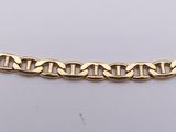 a close up of a gold chain on a white surface
