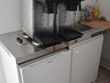 two coffee machines sitting on top of a counter