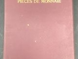 a red book with gold lettering sitting on top of a table