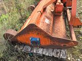 a rusted out machine that is sitting in the grass