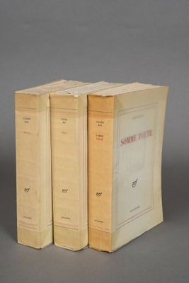 three books sitting on top of each other on a gray surface