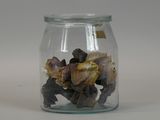 a glass jar filled with small pieces of food