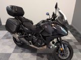 a black motorcycle that is parked on a checkered floor