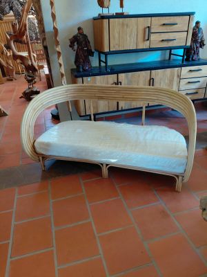 a couch that is sitting on a tile floor in a room