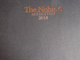 a close up of a black book with orange writing on it