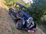 an old car that is parked on the side of the road