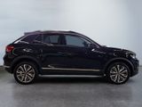 the black suv is parked in a large room with a white wall