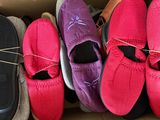 several pairs of shoes are lined up in a cardboard box