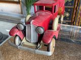a red toy truck that is on display in a glass case