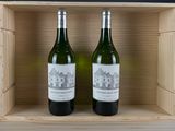two bottles of wine sitting in a wooden box on top of a table